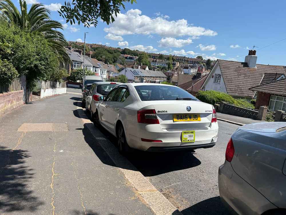 Photograph of DA15 WJD - a White Skoda Octavia taxi parked in Hollingdean by a non-resident. The nineteenth of nineteen photographs supplied by the residents of Hollingdean.