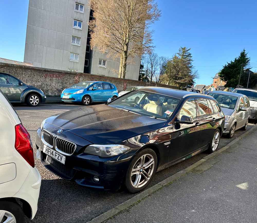 Photograph of HF14 FZV - a Black BMW 5 Series parked in Hollingdean by a non-resident, and potentially abandoned. The second of two photographs supplied by the residents of Hollingdean.