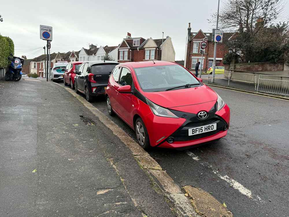 Photograph of BF15 HRO - a Red Toyota Aygo parked in Hollingdean by a non-resident who uses the local area as part of their Brighton commute. The second of four photographs supplied by the residents of Hollingdean.