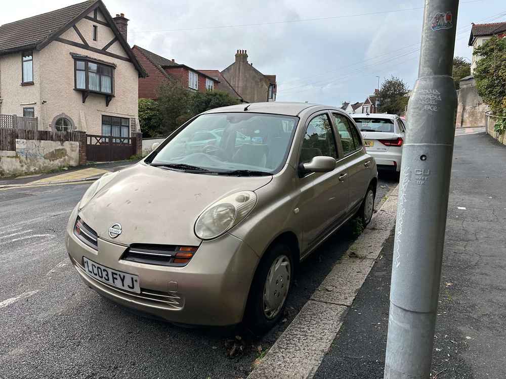 Photograph of LC03 FYJ - a Gold Nissan Micra parked in Hollingdean by a non-resident, and potentially abandoned. The ninth of twenty-eight photographs supplied by the residents of Hollingdean.
