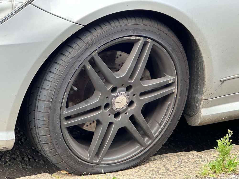 Photograph of ML61 AXH - a SIlver Mercedes E Class parked in Hollingdean by a non-resident, and potentially abandoned. The third of five photographs supplied by the residents of Hollingdean.