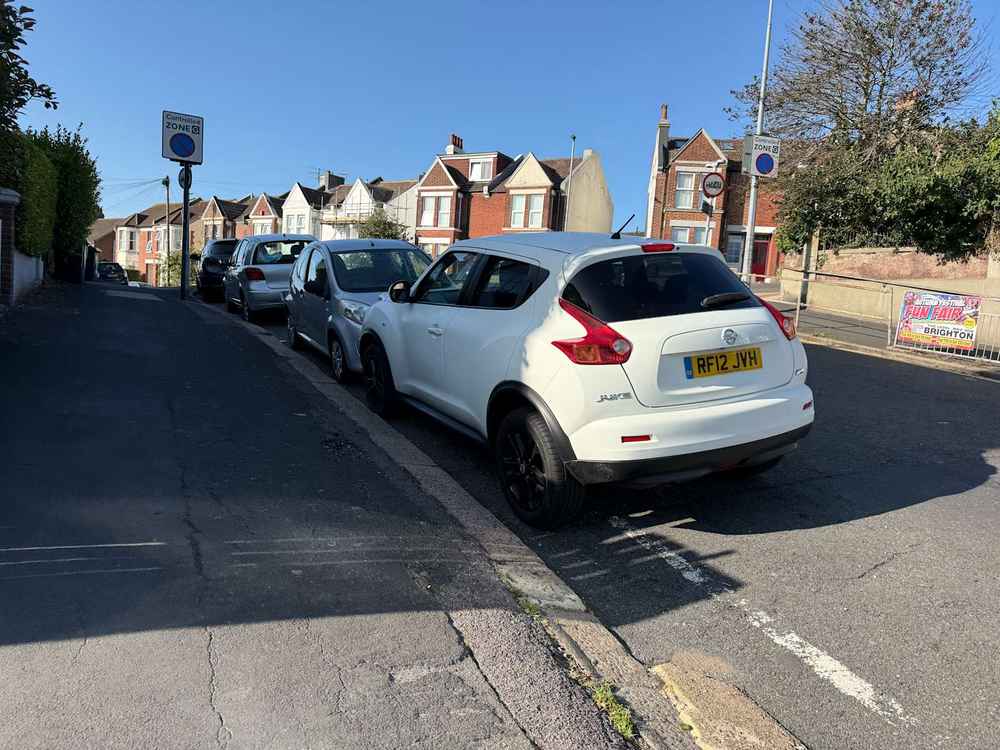 Photograph of RF12 JVH - a White Nissan Juke parked in Hollingdean by a non-resident who uses the local area as part of their Brighton commute. The eighteenth of twenty-five photographs supplied by the residents of Hollingdean.