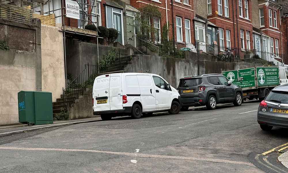 Photograph of MT60 CPE - a White Nissan NV200 parked in Hollingdean by a non-resident, and potentially abandoned. The fourth of fourteen photographs supplied by the residents of Hollingdean.