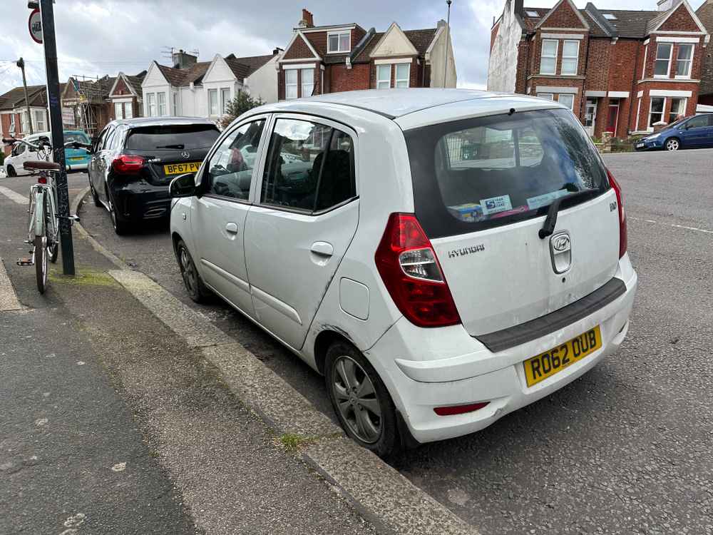 Photograph of RO62 OUB - a White Hyundai i10 parked in Hollingdean by a non-resident. The first of four photographs supplied by the residents of Hollingdean.