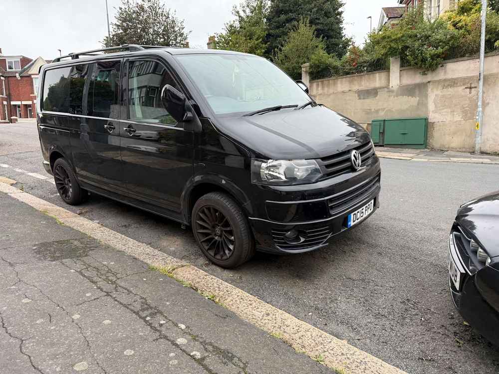 Photograph of DC15 PPO - a Black Volkswagen Transporter camper van parked in Hollingdean by a non-resident. 