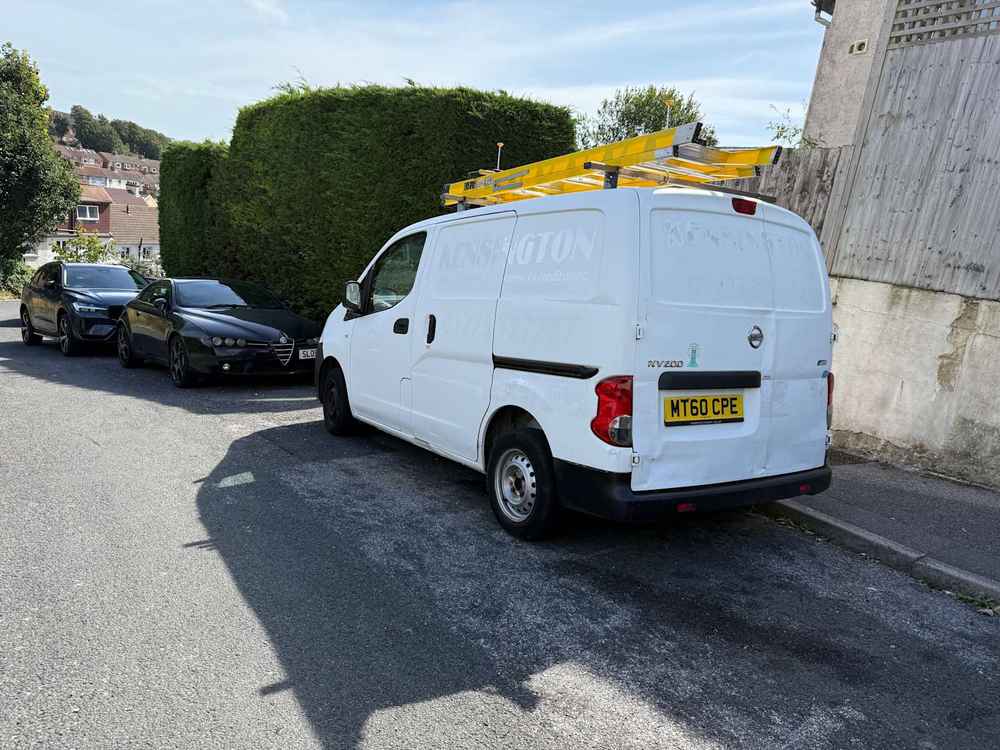 Photograph of MT60 CPE - a White Nissan NV200 parked in Hollingdean by a non-resident, and potentially abandoned. The tenth of fourteen photographs supplied by the residents of Hollingdean.