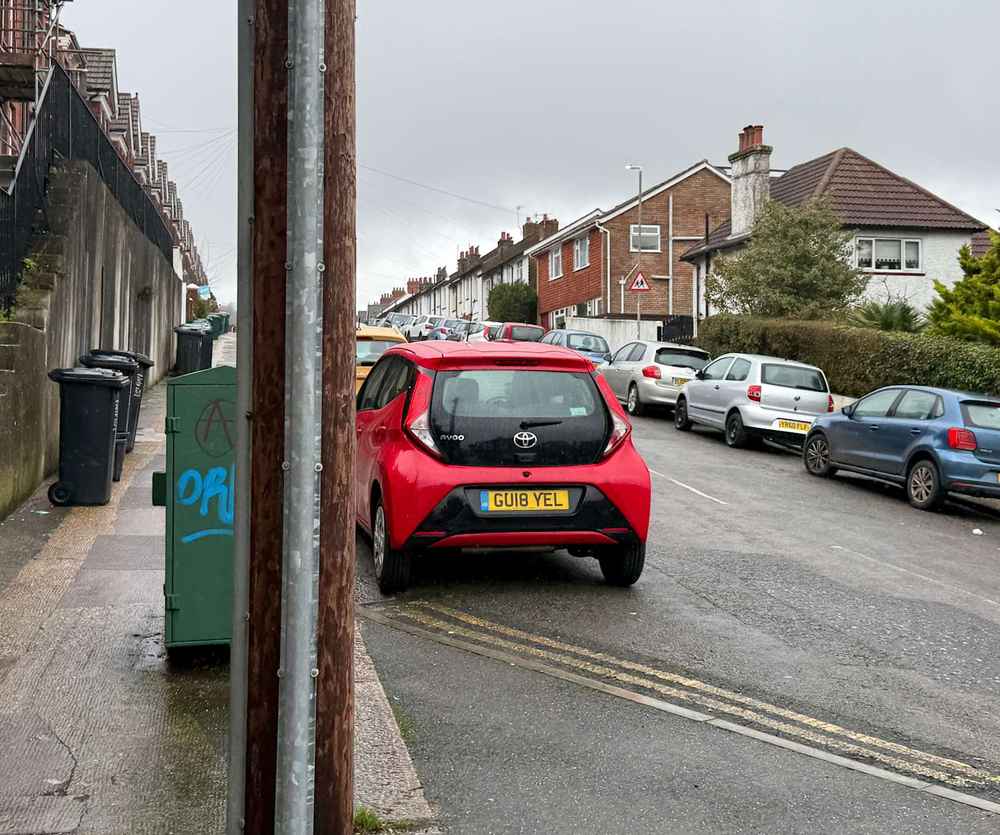Photograph of GU18 YEL - a Red Toyota Aygo parked in Hollingdean by a non-resident. The second of ten photographs supplied by the residents of Hollingdean.
