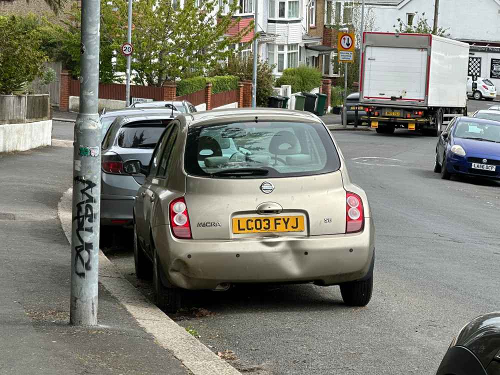 Photograph of LC03 FYJ - a Gold Nissan Micra parked in Hollingdean by a non-resident, and potentially abandoned. The sixteenth of twenty-three photographs supplied by the residents of Hollingdean.