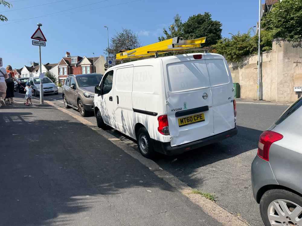 Photograph of MT60 CPE - a White Nissan NV200 parked in Hollingdean by a non-resident, and potentially abandoned. The seventh of seven photographs supplied by the residents of Hollingdean.