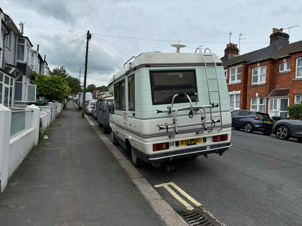 Photograph of R384 ORC - a Beige Volkswagen Transporter camper van parked in Hollingdean by a non-resident, and potentially abandoned. The thirteenth of thirteen photographs supplied by the residents of Hollingdean.