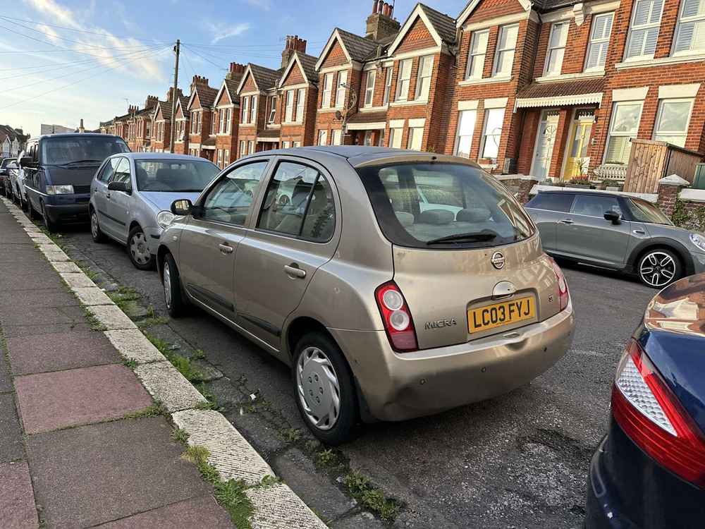 Photograph of LC03 FYJ - a Gold Nissan Micra parked in Hollingdean by a non-resident, and potentially abandoned. The fourth of twenty-eight photographs supplied by the residents of Hollingdean.
