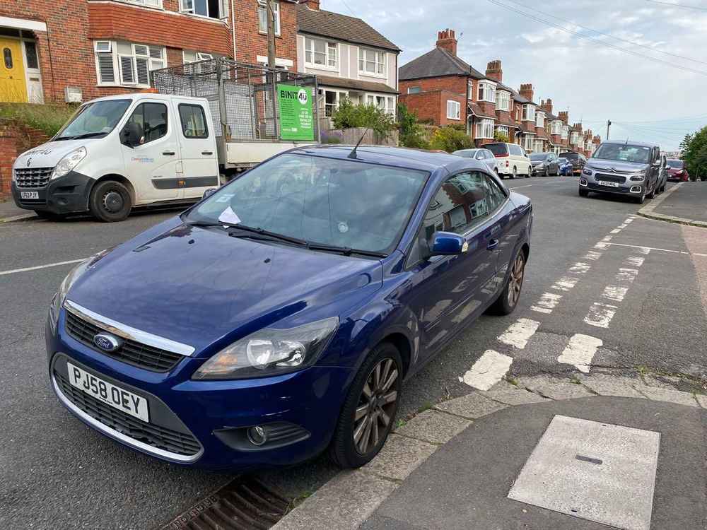 Photograph of PJ58 OEY - a Blue Ford Focus parked in Hollingdean by a non-resident. The first of two photographs supplied by the residents of Hollingdean.
