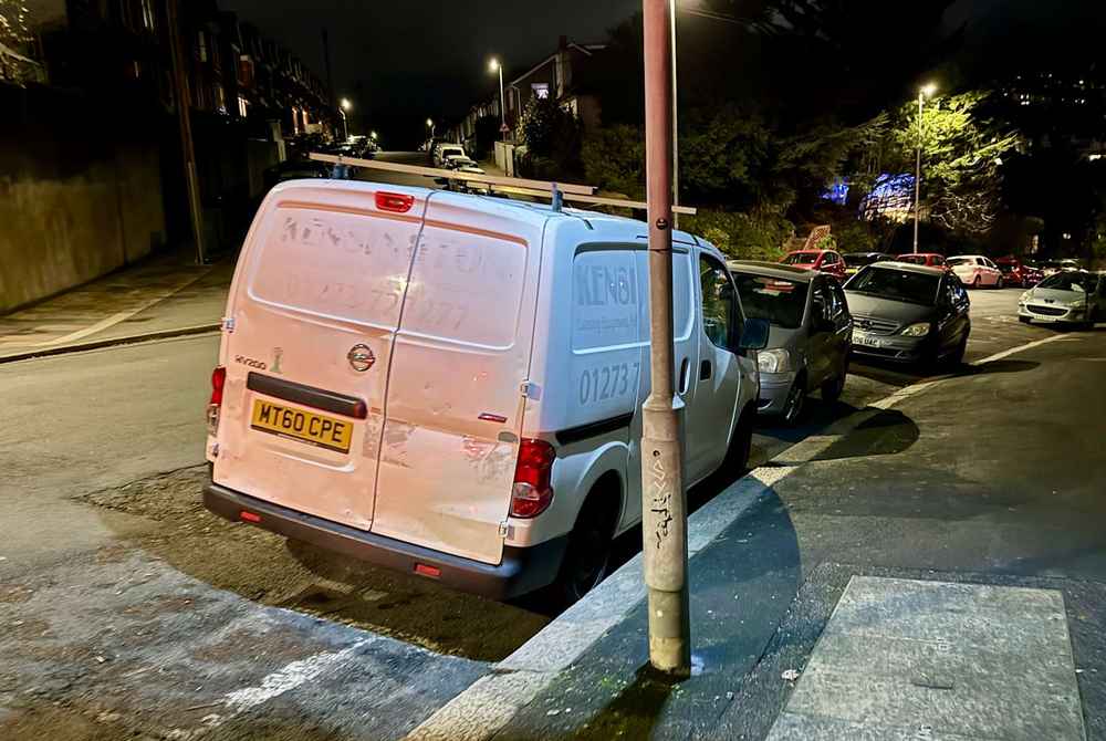 Photograph of MT60 CPE - a White Nissan NV200 parked in Hollingdean by a non-resident, and potentially abandoned. The fifteenth of fifteen photographs supplied by the residents of Hollingdean.