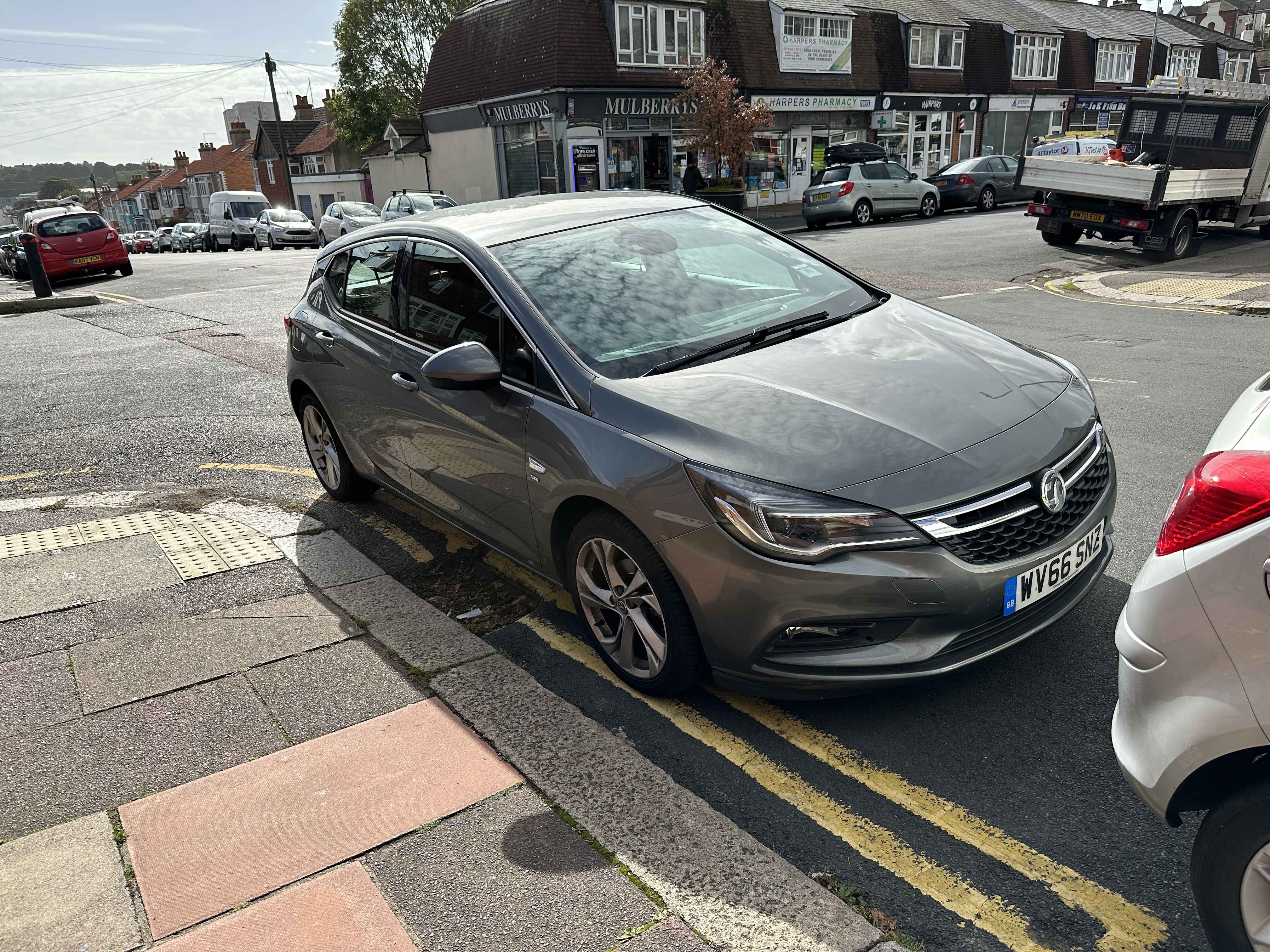 Photograph of WV66 SNZ - a Beige Vauxhall Astra parked in Hollingdean. The first of two photographs supplied by the residents of Hollingdean.