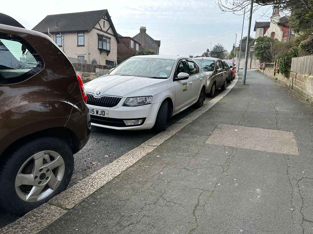 Photograph of DA15 WJD - a White Skoda Octavia taxi parked in Hollingdean by a non-resident. The sixth of nineteen photographs supplied by the residents of Hollingdean.