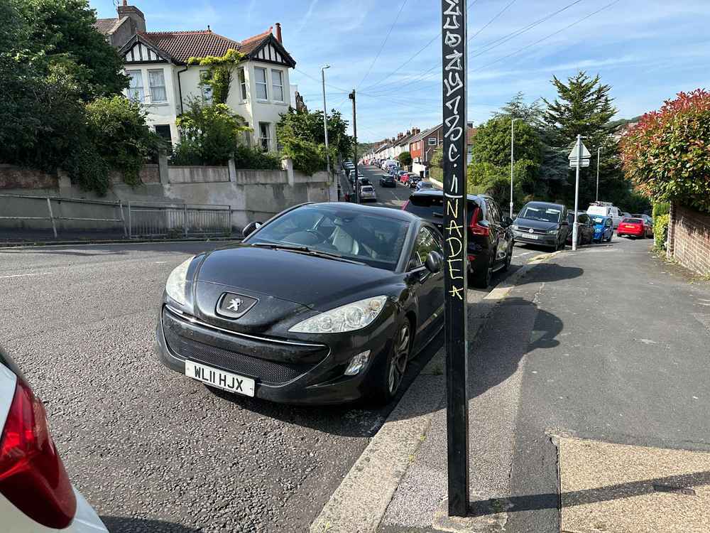 Photograph of WL11 HJX - a Blue Peugeot RCZ parked in Hollingdean by a non-resident. 