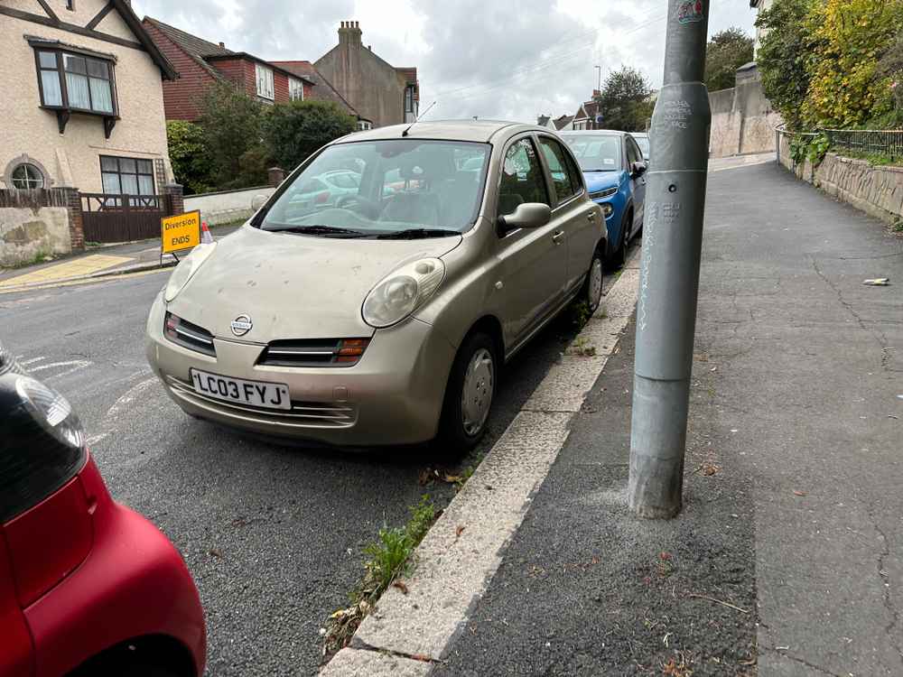 Photograph of LC03 FYJ - a Gold Nissan Micra parked in Hollingdean by a non-resident, and potentially abandoned. The seventh of twenty-three photographs supplied by the residents of Hollingdean.