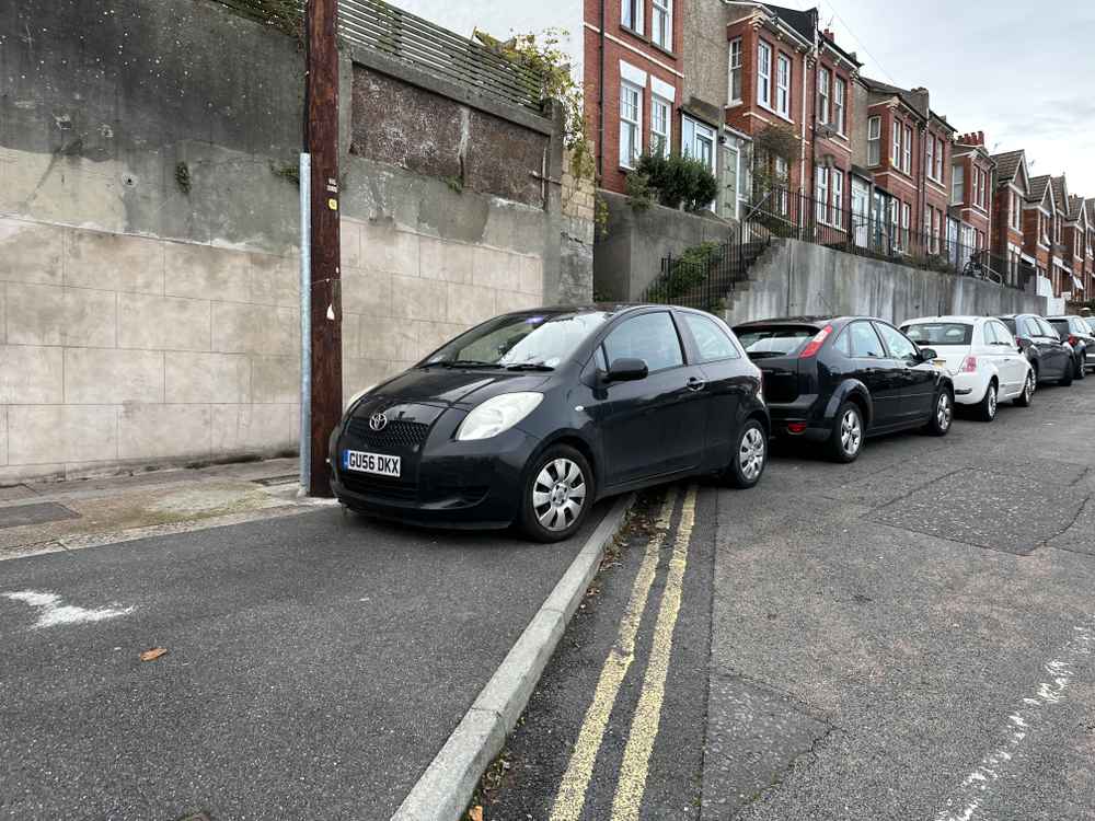 Photograph of GU56 DKX - a Black Toyota Yaris parked in Hollingdean by a non-resident who uses the local area as part of their Brighton commute. The first of two photographs supplied by the residents of Hollingdean.