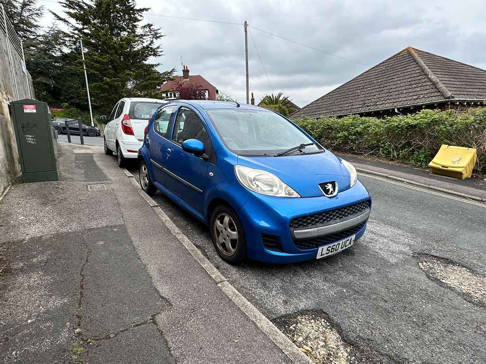 Photograph of LS60 UCA - a Blue Peugeot 107 parked in Hollingdean by a non-resident. The eleventh of thirty photographs supplied by the residents of Hollingdean.