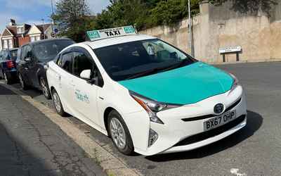 BX67 OHP, a White Toyota Prius parked in Hollingdean