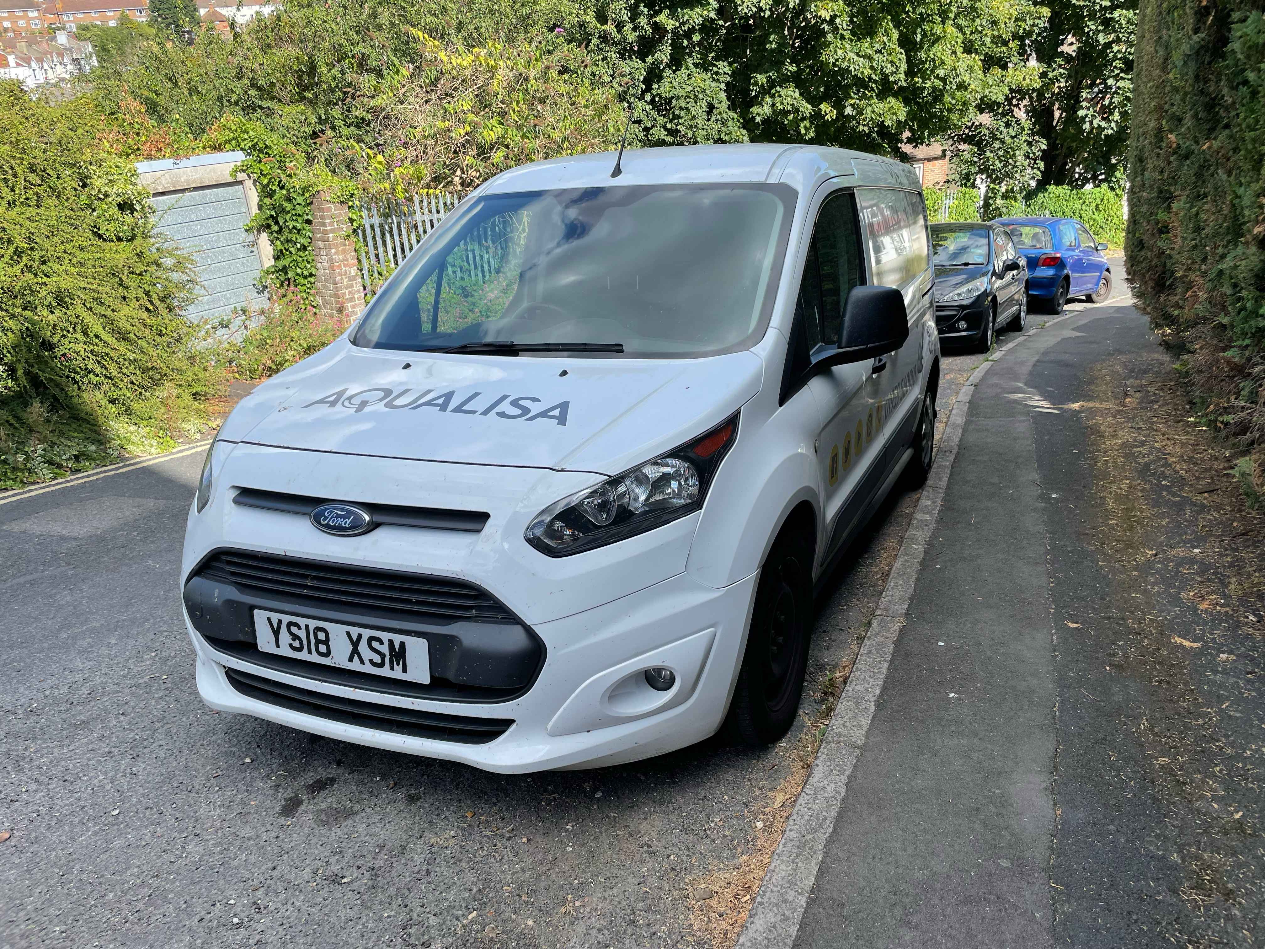 Photograph of YS18 XSM - a White Ford Transit Connect parked in Hollingdean by a non-resident. The first of five photographs supplied by the residents of Hollingdean.