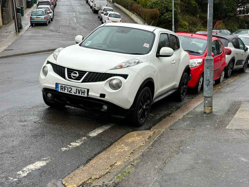 Photograph of RF12 JVH - a White Nissan Juke parked in Hollingdean by a non-resident who uses the local area as part of their Brighton commute. The second of eight photographs supplied by the residents of Hollingdean.