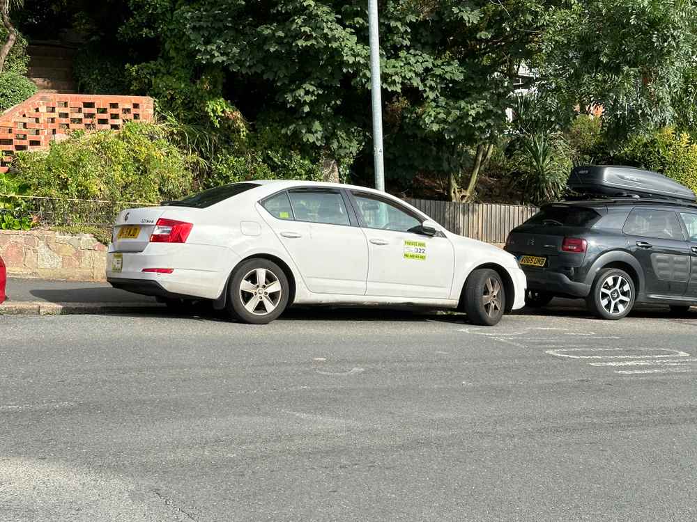 Photograph of DA15 WJD - a White Skoda Octavia taxi parked in Hollingdean by a non-resident. The twelfth of thirteen photographs supplied by the residents of Hollingdean.