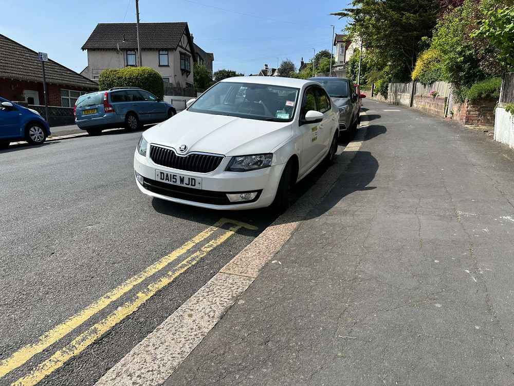 Photograph of DA15 WJD - a White Skoda Octavia taxi parked in Hollingdean by a non-resident. The tenth of nineteen photographs supplied by the residents of Hollingdean.