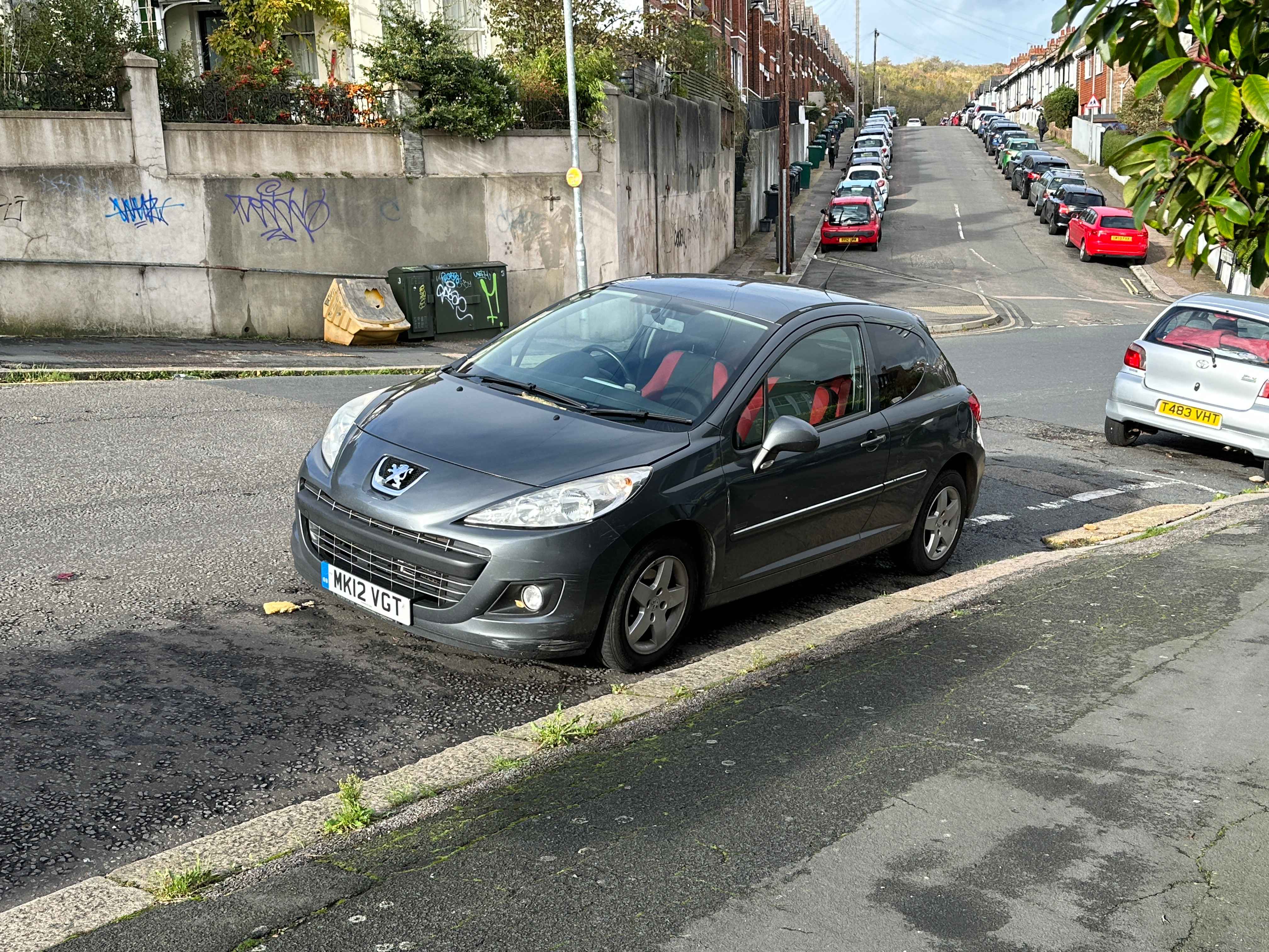 Photograph of MK12 VGT - a Grey Peugeot 207 parked in Hollingdean by a non-resident who uses the local area as part of their Brighton commute. The second of six photographs supplied by the residents of Hollingdean.