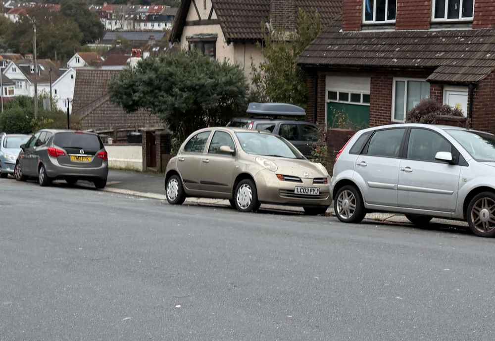 Photograph of LC03 FYJ - a Gold Nissan Micra parked in Hollingdean by a non-resident, and potentially abandoned. The twenty-second of twenty-eight photographs supplied by the residents of Hollingdean.