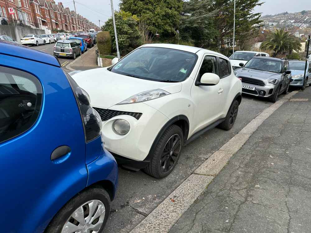 Photograph of RF12 JVH - a White Nissan Juke parked in Hollingdean by a non-resident who uses the local area as part of their Brighton commute. The fifth of eight photographs supplied by the residents of Hollingdean.