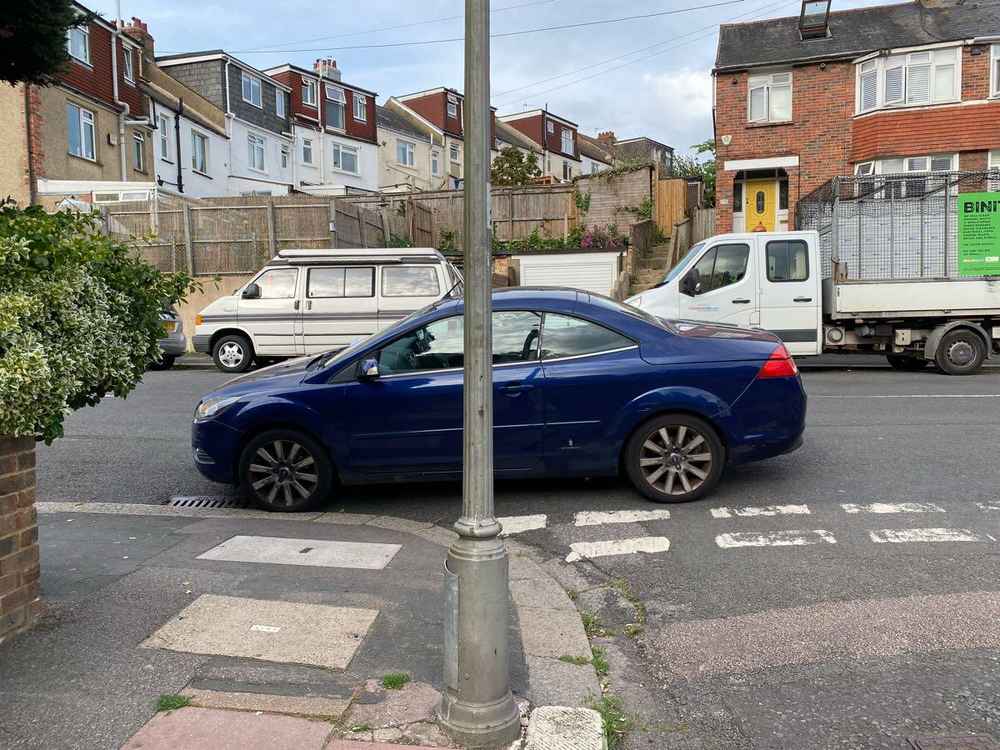 Photograph of PJ58 OEY - a Blue Ford Focus parked in Hollingdean by a non-resident. The second of two photographs supplied by the residents of Hollingdean.