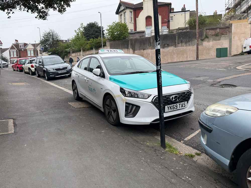 Photograph of YK69 TAS - a White Hyundai Ioniq taxi parked in Hollingdean by a non-resident. The seventh of fifteen photographs supplied by the residents of Hollingdean.