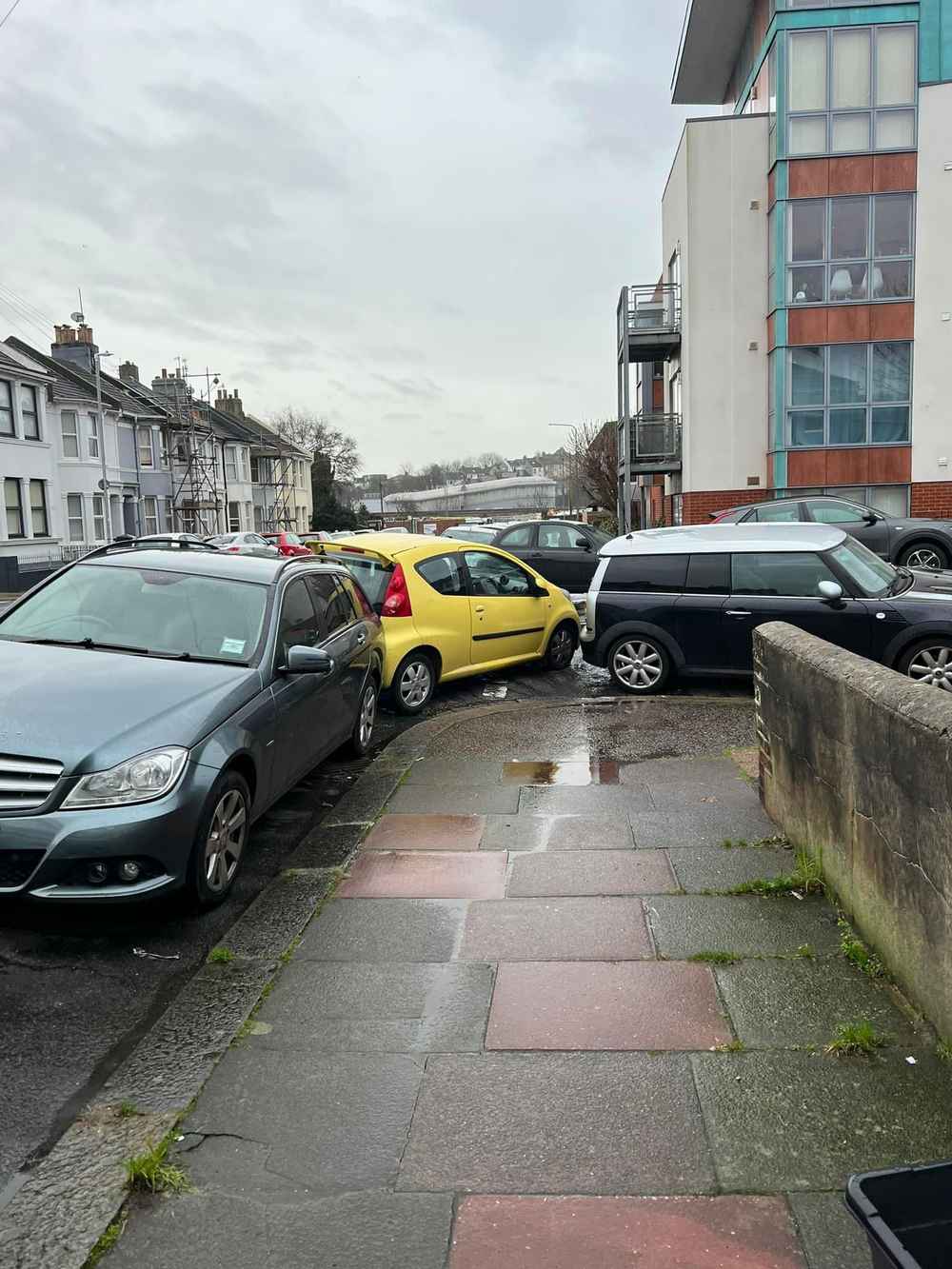 Photograph of AP07 OZS - a Yellow Peugeot 107 parked in Hollingdean by a non-resident who uses the local area as part of their Brighton commute. The first of two photographs supplied by the residents of Hollingdean.