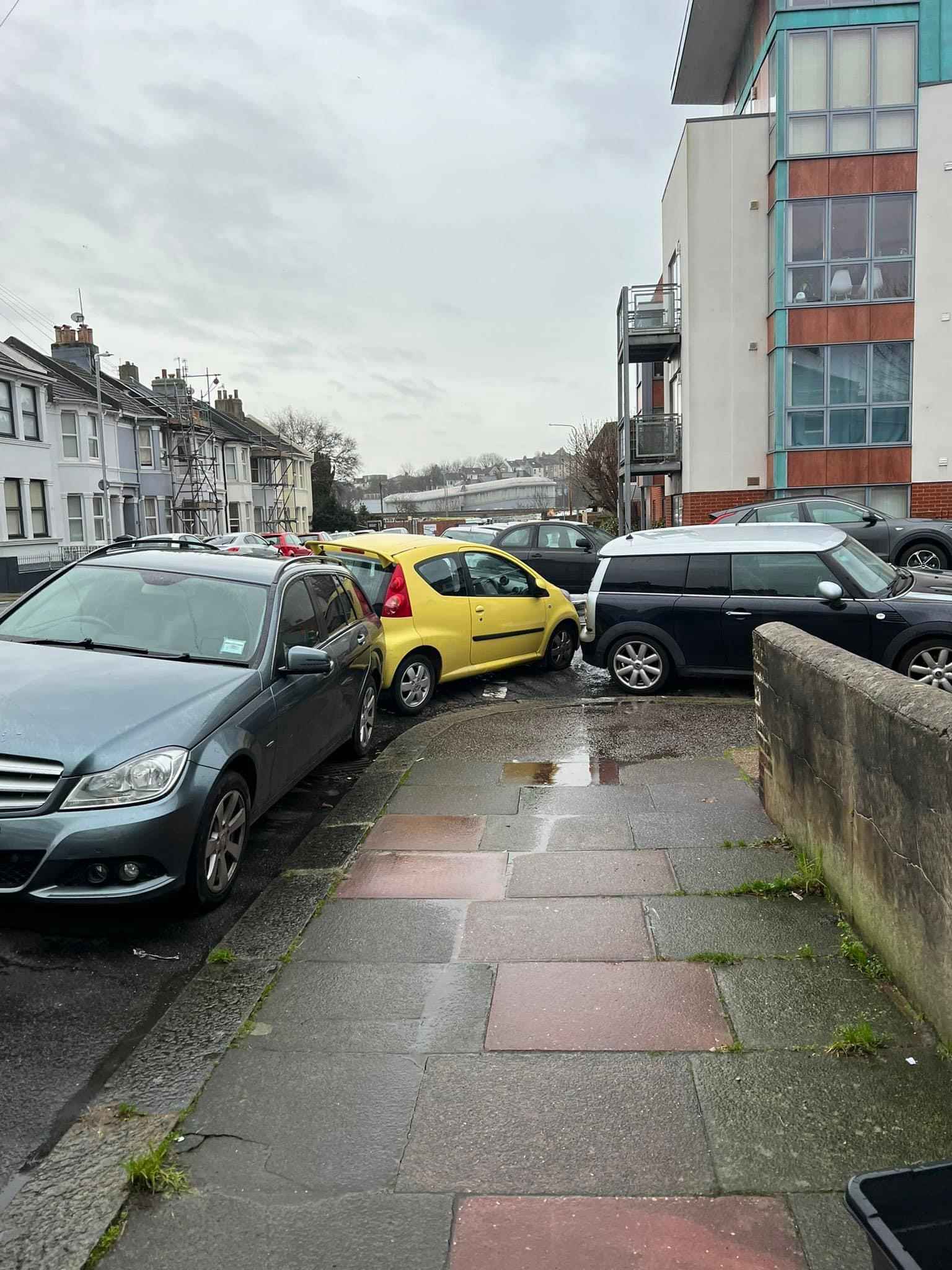 Photograph of AP07 OZS - a Yellow Peugeot 107 parked in Hollingdean by a non-resident who uses the local area as part of their Brighton commute. The first of two photographs supplied by the residents of Hollingdean.