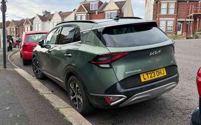 LT23 OHJ, a Green Kia Sportage parked in Hollingdean