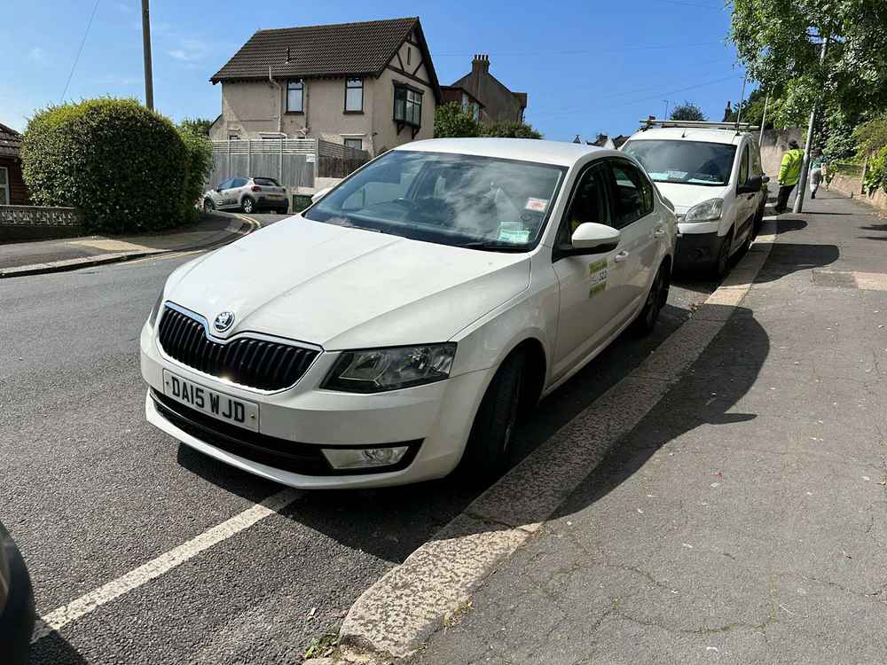 Photograph of DA15 WJD - a White Skoda Octavia taxi parked in Hollingdean by a non-resident. The ninth of nineteen photographs supplied by the residents of Hollingdean.