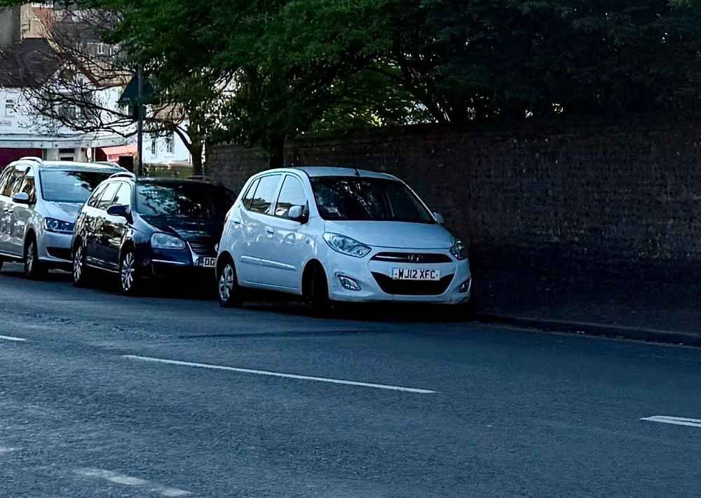 Photograph of WJ12 XFC - a White Hyundai i10 parked in Hollingdean by a non-resident, and potentially abandoned. The fourth of four photographs supplied by the residents of Hollingdean.