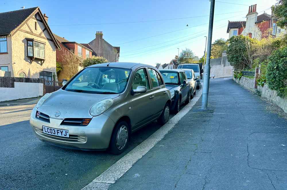 Photograph of LC03 FYJ - a Gold Nissan Micra parked in Hollingdean by a non-resident, and potentially abandoned. The thirteenth of twenty-three photographs supplied by the residents of Hollingdean.