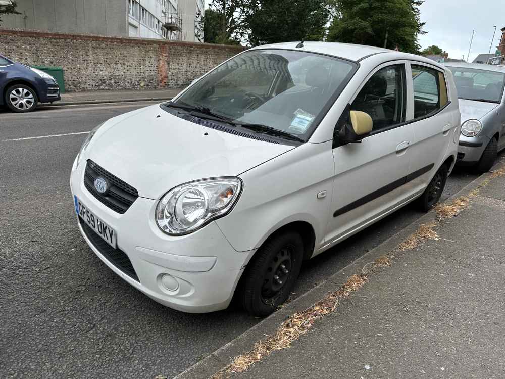 Photograph of GF59 UKY - a White Kia Picanto parked in Hollingdean by a non-resident, and potentially abandoned. The second of two photographs supplied by the residents of Hollingdean.