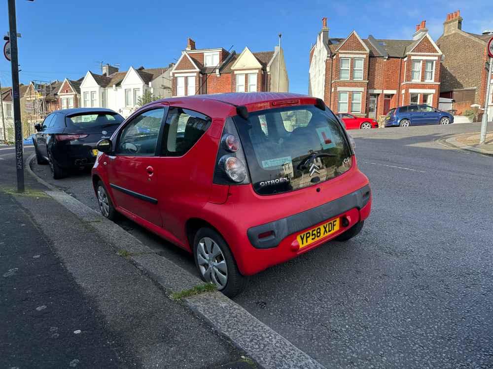 Photograph of YP58 XDF - a Red Citroen C1 parked in Hollingdean by a non-resident, and potentially abandoned. The seventh of seven photographs supplied by the residents of Hollingdean.