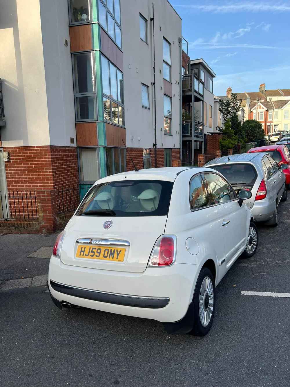 Photograph of HJ59 OMY - a White Fiat 500 parked in Hollingdean by a non-resident who uses the local area as part of their Brighton commute. The second of three photographs supplied by the residents of Hollingdean.