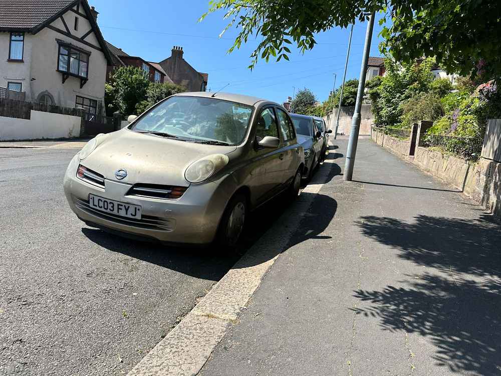 Photograph of LC03 FYJ - a Gold Nissan Micra parked in Hollingdean by a non-resident, and potentially abandoned. The seventeenth of twenty-eight photographs supplied by the residents of Hollingdean.