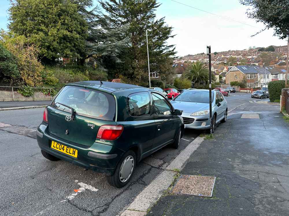 Photograph of LC04 ELW - a Green Toyota Yaris parked in Hollingdean by a non-resident. The ninth of twelve photographs supplied by the residents of Hollingdean.