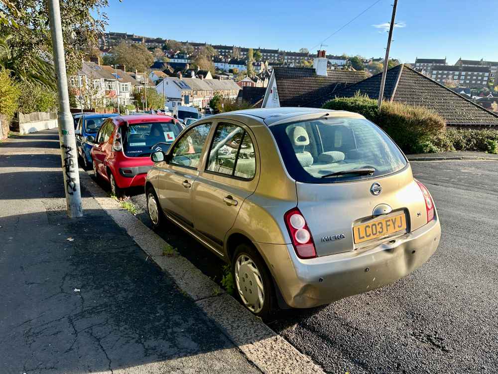 Photograph of LC03 FYJ - a Gold Nissan Micra parked in Hollingdean by a non-resident, and potentially abandoned. The eighth of twenty-three photographs supplied by the residents of Hollingdean.