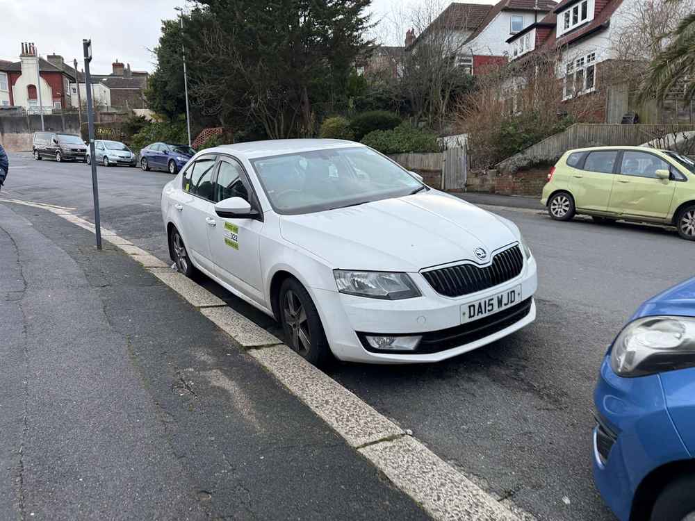 Photograph of DA15 WJD - a White Skoda Octavia taxi parked in Hollingdean by a non-resident. The fourteenth of nineteen photographs supplied by the residents of Hollingdean.
