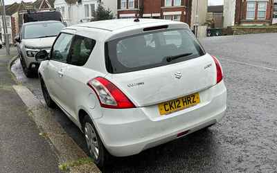 CK12 HRZ, a White Suzuki Swift parked in Hollingdean