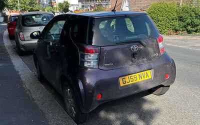 GJ59 NVA, a Purple Toota IQ parked in Hollingdean