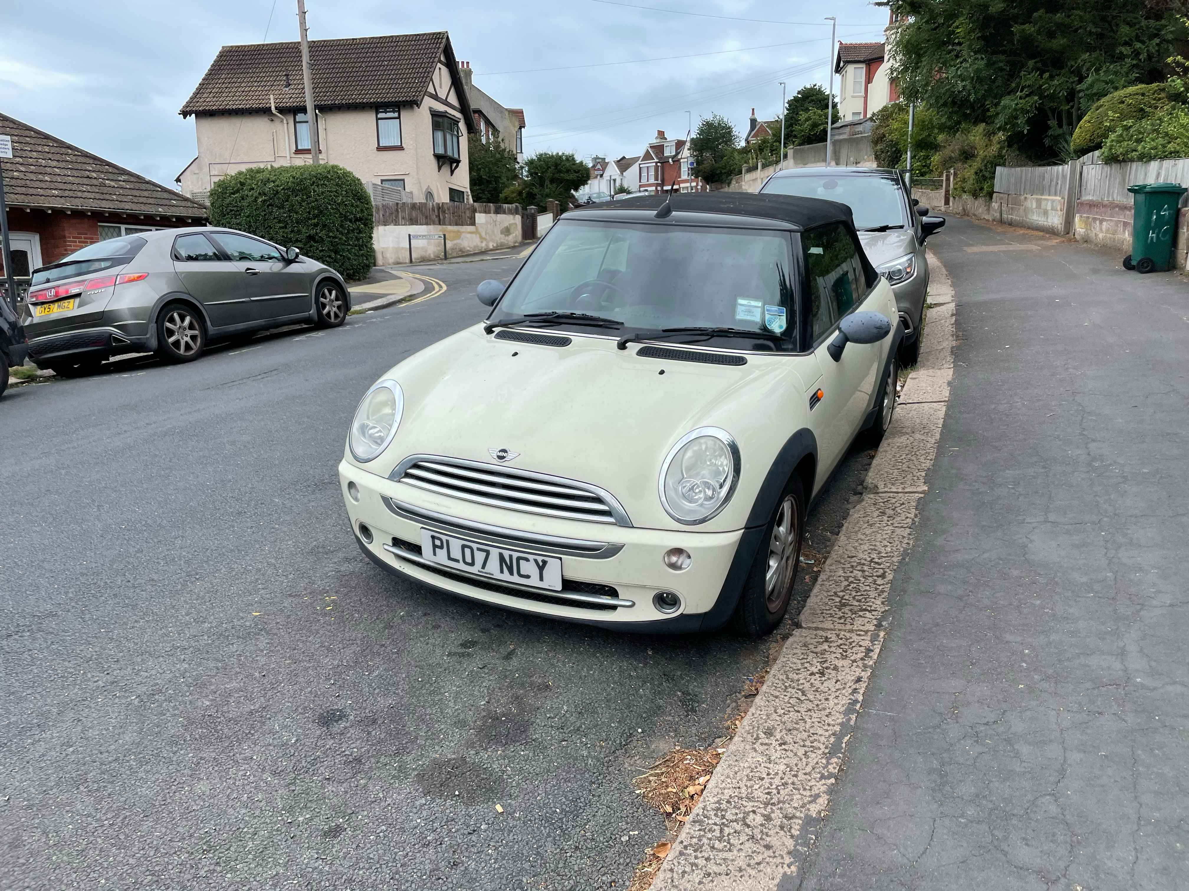 Photograph of PL07 NCY - a White Mini One parked in Hollingdean by a non-resident, and potentially abandoned. The second of two photographs supplied by the residents of Hollingdean.