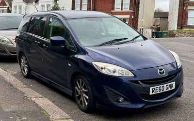 RE60 GNK, a Blue Mazda 5 parked in Hollingdean